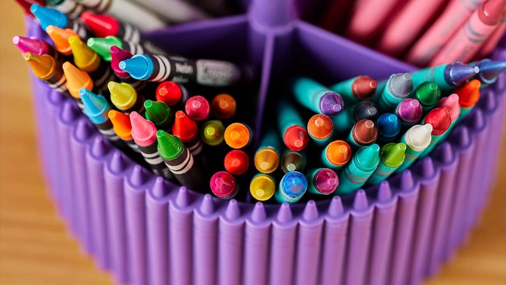 Crayons in a purple display container