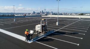 Professional Line Marking Equipment: Tools Used by Industry Experts When facility managers across Auckland, Hamilton, Waikato, Tauranga, and Whangarei need precision line marking equipment, understanding the difference between amateur-grade tools and professional machinery becomes crucial for project success. Whether you're managing a warehouse in South Auckland, overseeing school facilities in the Bay of Plenty, or maintaining sports facilities across the upper North Island, the technology behind modern line marking machines directly impacts safety compliance, operational efficiency, and long-term cost effectiveness. The global line marking equipment market demonstrates remarkable growth, valued at approximately 3.2 billion in 2024 and projected to reach 5.8 billion by 2033. This expansion reflects increasing demand for precision marking solutions driven by infrastructure development, safety regulations, and technological advancement across New Zealand and internationally. The Challenge: Choosing Professional vs. Basic Line Marking Tools Many business owners face the same question: invest in basic spray paint tools for in-house maintenance, or partner with professionals who utilize advanced line marking machines? The answer lies in understanding how professional line marking equipment differs fundamentally from hardware store alternatives. Basic spray cans and manual tape applications might seem cost-effective initially, but they rarely meet New Zealand's strict compliance standards for commercial and industrial applications. Poor quality application methods compromise safety compliance, require frequent reapplication, and ultimately cost more than professional solutions utilizing precision marking machines. In New Zealand's challenging climate conditions—from Auckland's coastal humidity to Waikato's temperature variations—the right line marking equipment and marking paint formulations become essential for reliable performance and regulatory compliance. Essential Categories of Professional Line Marking Equipment Manual and Semi-Automatic Line Marking Machines Manual line marking machines represent entry-level professional equipment designed for smaller-scale projects where precision remains critical. These lightweight units require operators to guide them along surfaces, featuring adjustable width controls and consistent paint flow mechanisms. Manual machines excel at sports field applications, court marking, and smaller commercial areas where accurate positioning matters. Semi-automatic machines bridge the gap between manual systems and fully automated solutions, incorporating motor-powered mechanisms that reduce operator fatigue while maintaining cost efficiency. These units offer enhanced paint concentrate delivery systems, adjustable line width settings, and improved application consistency for medium-scale projects such as marking car parks and educational facility layouts. Advanced Automatic Line Marking Technology Fully automatic line marking machines represent the pinnacle of marking technology, designed for large-scale infrastructure projects requiring minimal human intervention. These sophisticated systems deploy GPS guidance, computer-controlled paint application, and real-time monitoring capabilities that ensure accurately positioned markings every time. Modern automatic systems incorporate laser guidance technology that eliminates human error and maintains consistent spacing, crucial for meeting New Zealand's safety and compliance standards. Heavy-duty automatic machines feature high-quality paint delivery systems, precision guide mechanisms, and reliable operation in challenging industrial environments. Specialized Equipment for Different Surface Applications Sports Field and Grass Marking Solutions Sports field marking requires specialized equipment designed for natural grass and synthetic surfaces. Professional field marking machines feature low ground pressure wheels to prevent turf damage, paint concentrate dilution systems for cost-effective coverage, and quick-change accessory attachments for different sports requirements. String line guides ensure perfect rectangles for football pitches and regulation court markings, while specialized marking spray systems accommodate both temporary and permanent applications. Sports clubs and schools across the upper North Island rely on this precision equipment to maintain regulation compliance for competitive play. Industrial and Warehouse Applications Industrial line marking equipment serves critical safety and operational functions in manufacturing, warehousing, and distribution facilities. These heavy-duty applications include traffic lane markings for forklifts and pedestrians, safety zone boundaries, equipment placement markers, and emergency evacuation area designations. Professional warehouse marking systems employ colour-coded approaches: yellow indicates caution areas and traffic lanes, white marks general areas and storage zones, red designates fire safety equipment zones, and black-yellow diagonal stripes mark permanent hazard areas. This standardized type of marking ensures immediate recognition of different zones and safety requirements. Road and Hard Surface Marking Technology Road marking represents the most demanding application of professional line marking equipment. These marking machines must withstand extreme weather conditions, heavy traffic loads, and maintain visibility in all lighting conditions while meeting stringent New Zealand Transport Agency specifications. Professional road marking contractors utilize advanced thermoplastic application systems for permanent installations and specialized marking paint formulations for standard applications. Fleet line markers and truck-mounted systems provide efficiency for large-scale infrastructure projects, while ride-on units offer precision for complex intersection and pedestrian crossing applications. Advanced Technology Integration in Modern Equipment GPS and Satellite-Guided Systems GPS line marking technology represents a significant advancement in equipment precision and efficiency. These systems utilize Global Positioning System technology to determine exact positioning through satellite signal reception, typically requiring a minimum four satellite signals for accurate positioning. Advanced GPS systems achieve accuracy within 5mm using RTK plotter technology and satellite-supported systems. Such precision enables completion of standard football pitch marking in approximately 25 minutes, significantly improving productivity while maintaining professional quality standards essential for comprehensive line marking solutions. Robotic and Automated Systems Robotic line marking systems represent the cutting edge of equipment technology, offering autonomous operation capabilities that reduce labor requirements and enhance precision. These systems integrate advanced navigation, automated paint application, and real-time monitoring to deliver consistent results across various applications. Advanced robot systems demonstrate this technology's potential with competitive positioning against traditional manual marking methods. The systems' high-quality paint capacity optimizes material usage while supporting eco-friendly initiatives through reduced waste and precise application control. Smart Marking and IoT Integration Smart road marking technology incorporates AI, IoT, and advanced reflective materials to create intelligent traffic control systems. These markings provide real-time traffic guidance, self-illumination capabilities, and support for autonomous vehicle navigation through embedded sensors and wireless communication systems. Material Quality and Application Systems Professional Paint and Coating Systems Professional line marking equipment requires specialized marking paint formulations designed for New Zealand conditions. Thermoplastic compounds provide premium durability for high-traffic road and car park applications, while water-based acrylic paints offer environmental friendliness and quick drying times for indoor applications. Marking spray systems must accommodate various material viscosities, from thin paints to thick thermoplastic compounds. High-quality spray equipment ensures consistent colour saturation, precise line edges, and optimal material adhesion across different surface types from concrete to synthetic materials. Precision Application Control Advanced line marking machines incorporate sophisticated application control systems that maintain consistent material flow rates, precise line width, and optimal spray patterns. These systems prevent over-application that wastes material and under-application that compromises visibility and durability. Professional equipment features multiple paint reservoir systems for complex colour schemes, quick-change capabilities for different product types, and automated cleaning cycles that maintain consistent performance between applications. Quality Assurance Through Professional Equipment Standards Compliance and Safety Integration Professional line marking equipment ensures compliance with New Zealand standards, including NZS 4121:2001 for accessibility requirements and WorkSafe guidelines for industrial applications. Safety compliance demands precise dimensional accuracy, consistent visibility, and a durable application that maintains effectiveness over time. Professional car park line marking projects require equipment capable of creating regulation-compliant disabled parking spaces, directional arrows, and traffic flow patterns that meet both safety and legal requirements across commercial and public facilities. Surface Preparation Integration Advanced line marking equipment works seamlessly with surface preparation systems to ensure optimal paint adhesion and longevity. Professional contractors utilize high-quality preparation equipment, including pressure washing systems, scarification machines for removing old markings, and shot-blasting equipment for optimal surface preparation. Proper surface preparation directly impacts marking adhesion and longevity, making specialized preparation equipment essential for professional results that withstand New Zealand's challenging climate conditions and heavy use patterns. Regional Expertise and Equipment Selection Upper North Island Applications Understanding New Zealand's unique conditions—from coastal salt air affecting equipment in Auckland to temperature variations in inland Waikato—requires both quality equipment and local expertise. Professional line marking contractors in Auckland combine advanced technology with an understanding of regional compliance requirements and access considerations. The investment in professional-grade line marking equipment pays dividends through reduced maintenance, improved safety compliance, and long-term cost effectiveness. While basic spray paint applications might seem economical initially, professional equipment delivers accurately applied, durable markings that protect facility investments. Specialized Applications Across Service Areas Hamilton's industrial base creates demand for specialized warehouse line marking equipment and manufacturing facility applications requiring expertise in safety compliance and material handling optimization. Tauranga's port operations demand logistics facility marking systems capable of handling container storage areas and heavy equipment traffic management. Whangarei's mix of community facilities and industrial operations requires versatile line marking equipment capabilities spanning multiple application types while maintaining competitive pricing for smaller community projects throughout the region. Making the Right Equipment Investment Decision Project Scale and Frequency Considerations For most commercial and institutional applications, partnering with contractors who have invested in professional line marking equipment proves more cost-effective than attempting to handle projects in-house. Large car park facilities, sports complexes, and industrial sites benefit from heavy-duty machine capabilities that ensure consistent quality across extensive area coverage. Facilities requiring regular re-marking benefit from professional relationships rather than equipment ownership and maintenance responsibilities. Construction projects and infrastructure developments often mandate professional-grade application standards achievable only with specialized equipment and operator expertise. Technical Complexity and Compliance Demands Multi-colour projects, curved lines, and precision layouts require advanced guide systems and operator expertise that justify professional equipment investment. Safety and regulatory requirements often mandate professional-grade application standards that ensure long-term compliance and performance. Professional line marking equipment delivers consistent application thickness, precise paint flow controls, and exact specifications required by New Zealand standards, ensuring markings meet safety and regulatory requirements while providing optimal visibility and durability. Expert Line Marking Solutions Across New Zealand Understanding professional line marking equipment helps facility managers appreciate the value of expert application, but the real benefit comes from partnering with experienced contractors who combine advanced technology with local knowledge and compliance expertise. At Line Marking Pros, we've invested in the latest laser-guided line marking machines, precision application systems, and high-quality marking materials specifically chosen for New Zealand conditions. Our fleet of professional equipment ensures your project meets compliance standards while delivering long-lasting results across Auckland, Hamilton, Waikato, Tauranga, and Whangarei. Whether you need sports line marking for educational facilities, precision warehouse safety marking, or comprehensive commercial facility solutions, our professional equipment and expertise guarantee results that exceed expectations while maintaining the highest safety and compliance standards. Ready to experience the difference professional line marking equipment makes? Contact Line Marking Pros today for a free consultation and comprehensive quote. Call 027 404 4550 or request your assessment online. Let our expertise and advanced technology transform your facility into a safer, more organized space that meets New Zealand's highest standards for safety, compliance, and operational excellence.